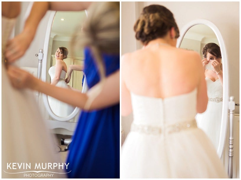 bride putting on wedding dress